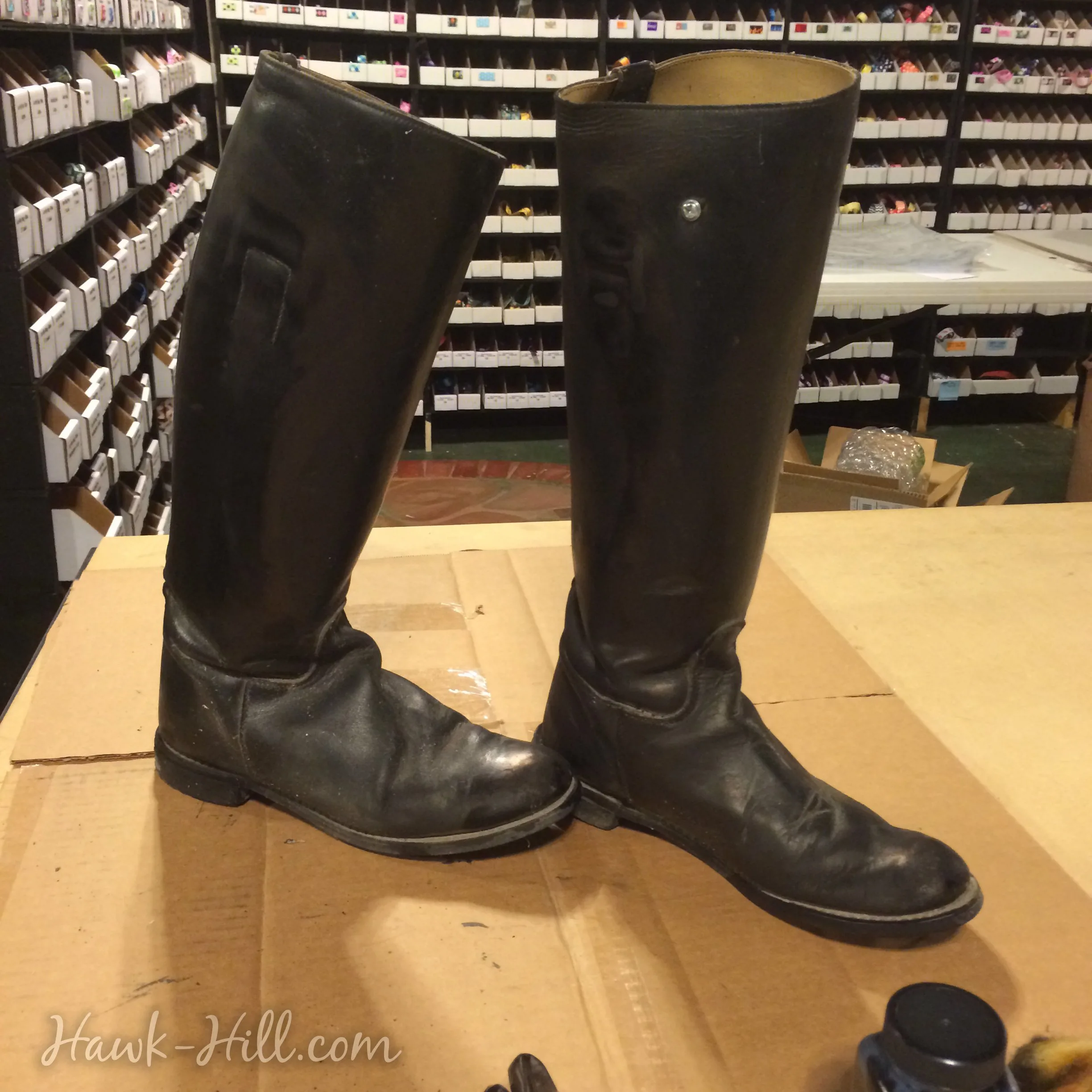 Worn leather riding boots looking new with an application of dye.