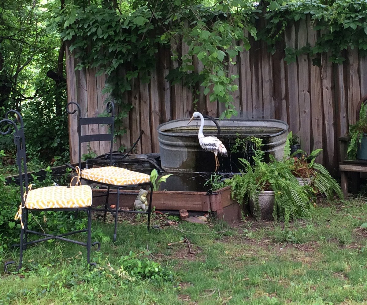 2014 pond set up with seating and metal yard art heron