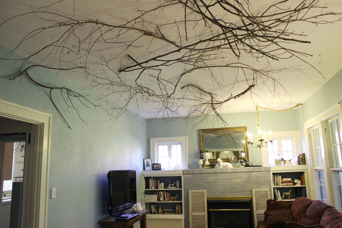Use branches to break up the angular lines of a high ceiling and add warmth to a room
