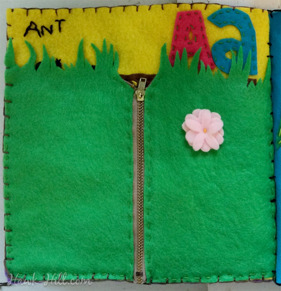 A page of quiet book unzips to reveal an ant farm!