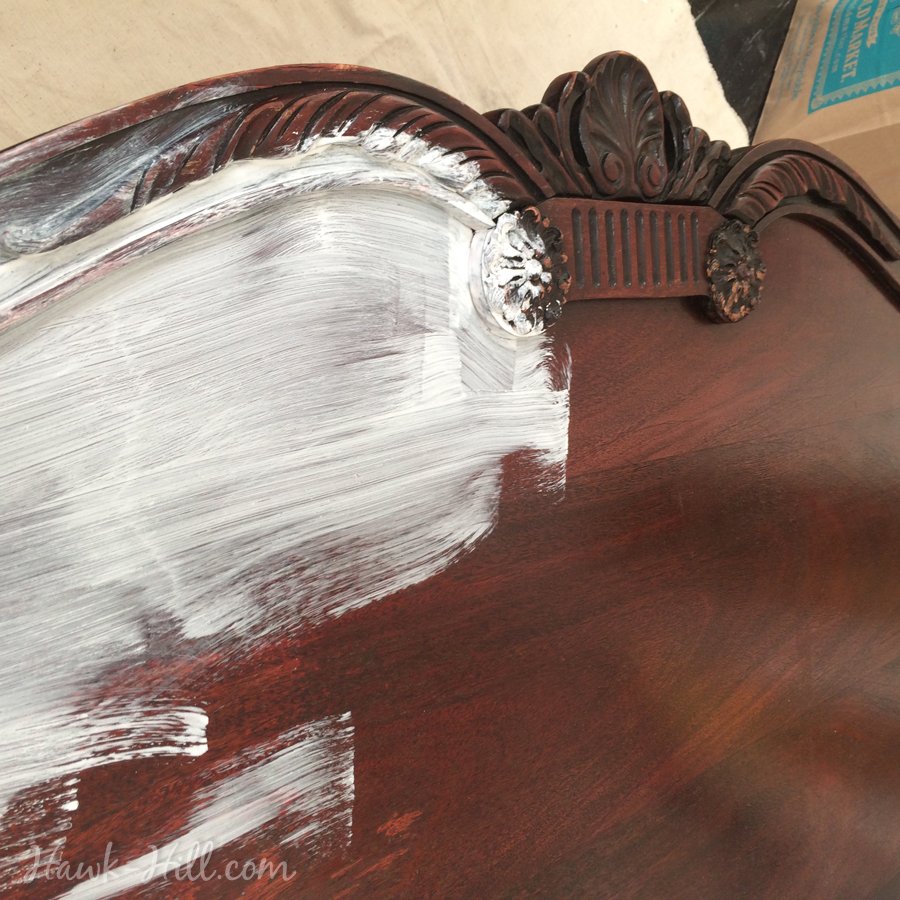 Ornate vintage headboard getting first coat of primer.