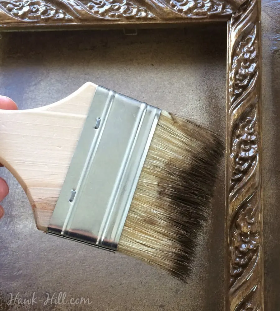 Use a paintbrush to get the brown paint deep into crevices