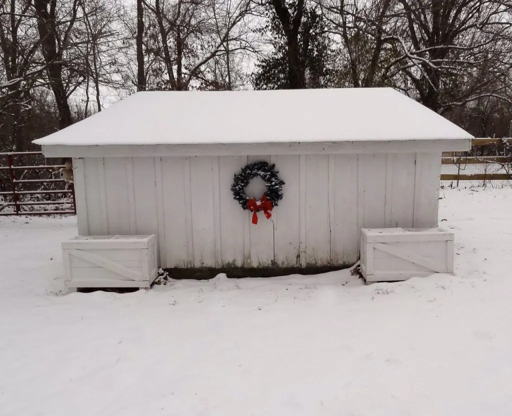 Farm outbuilding in snow with christmas wreath