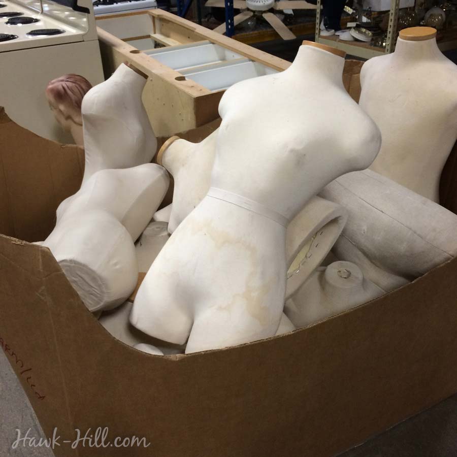 Dress forms in a shipping box at a Restore. 