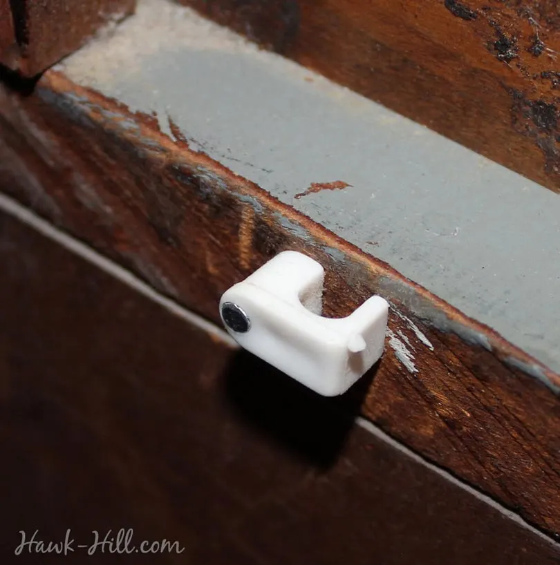 cable clip on the back of a vintage dresser