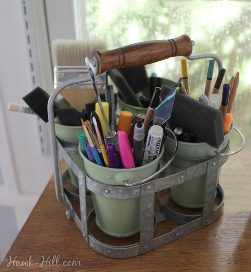 A picnic flatware caddy used for art supply storage.