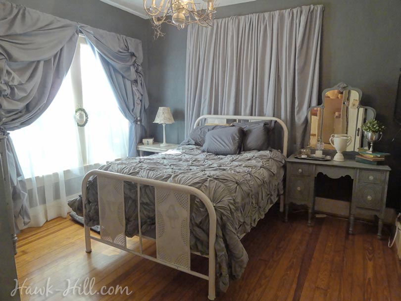 Anthropologie rosette quilt, vintage furniture, and romantic curtains in my master bedroom
