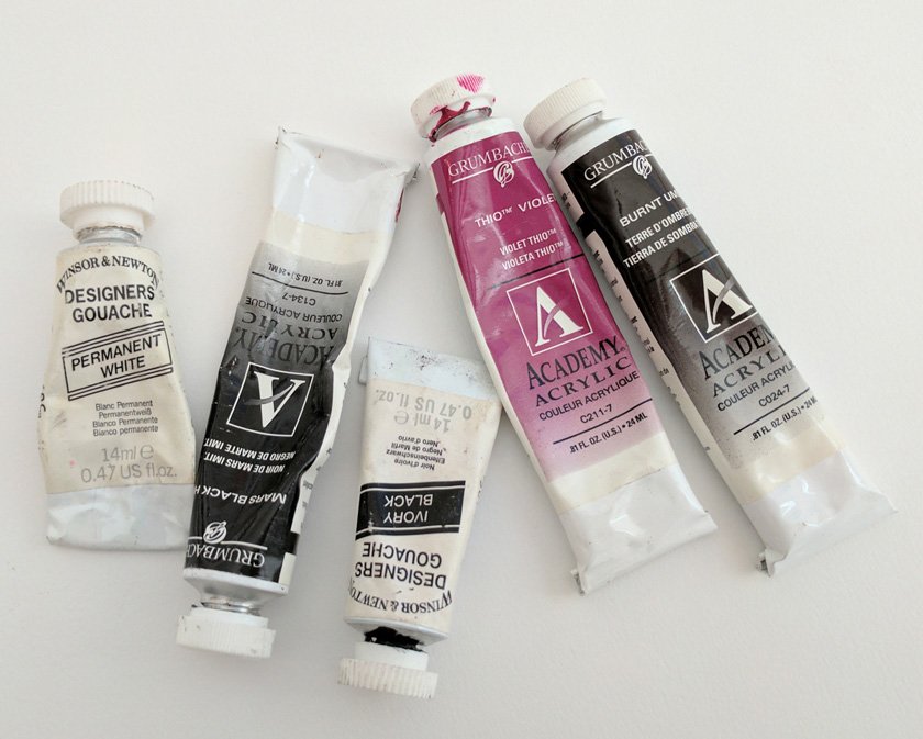 Small tubes of half-used watercolor paint.