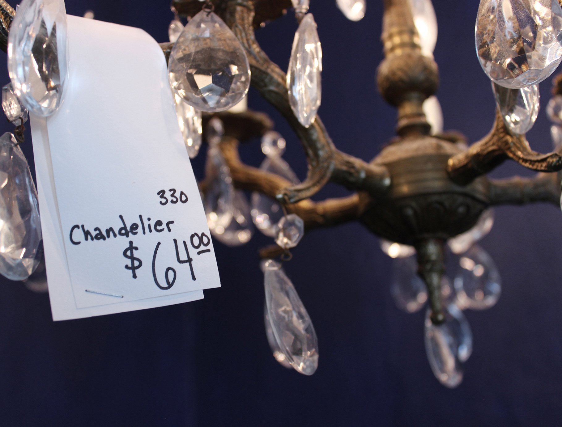 Chandeliers sell well in a flea market, large pricetags discourage excessive handling of these fragile items.
