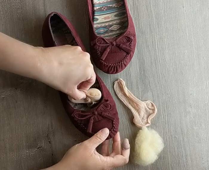Push the little pillow of wool into the toe of your shoe. It will make the inside of your shoe a little smaller in the most comfortable way possible