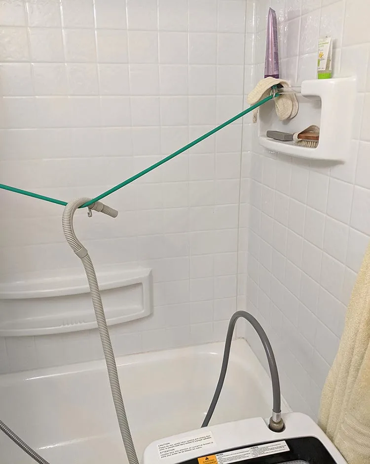 The drain hose needs to be placed in a position where it won't shift when water is pumped through it at velocity. Using a resistance band to hold mine over the tub, with tension, keeps the water draining safely over the tub