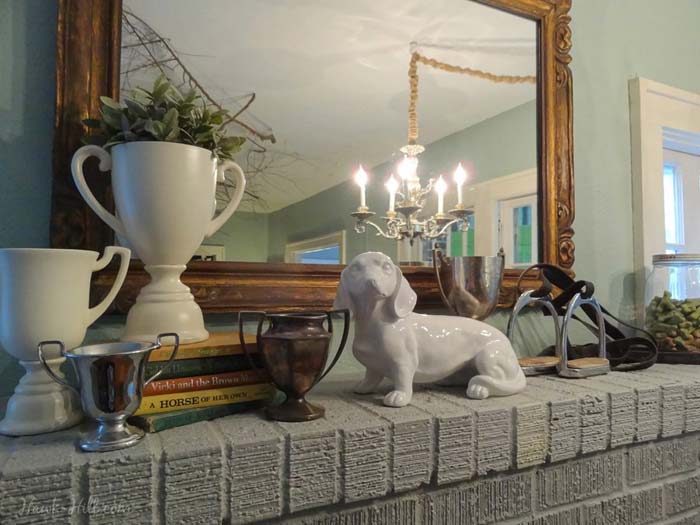A collection of decorations on a grey mantle.