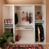 An IKEA wardrobe with bead board wallpaper attached.