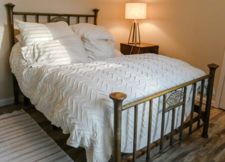 A modern adjustable bed and hybrid mattress with an antique bedframe.