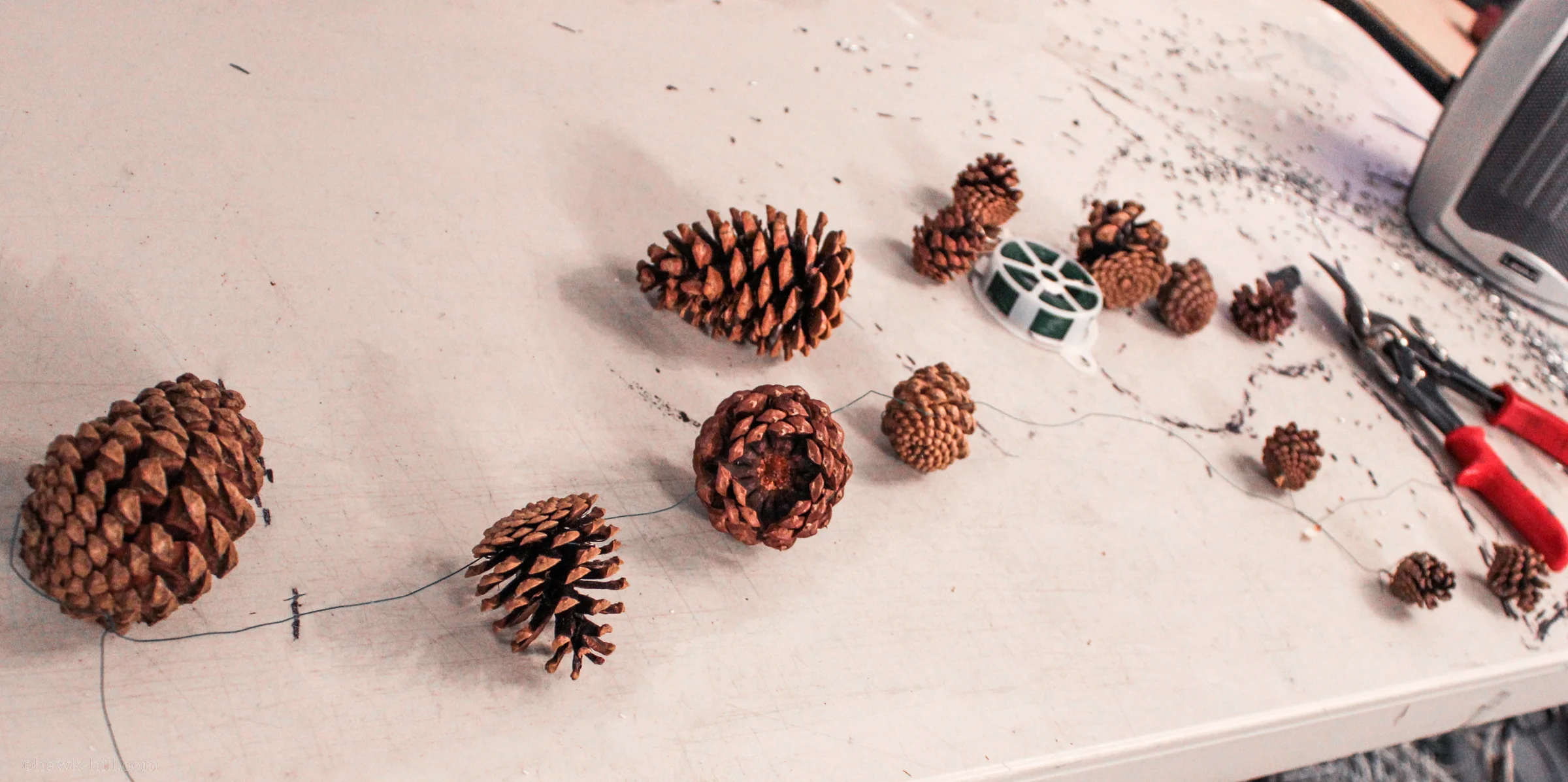 pinecones on a table, wired together.