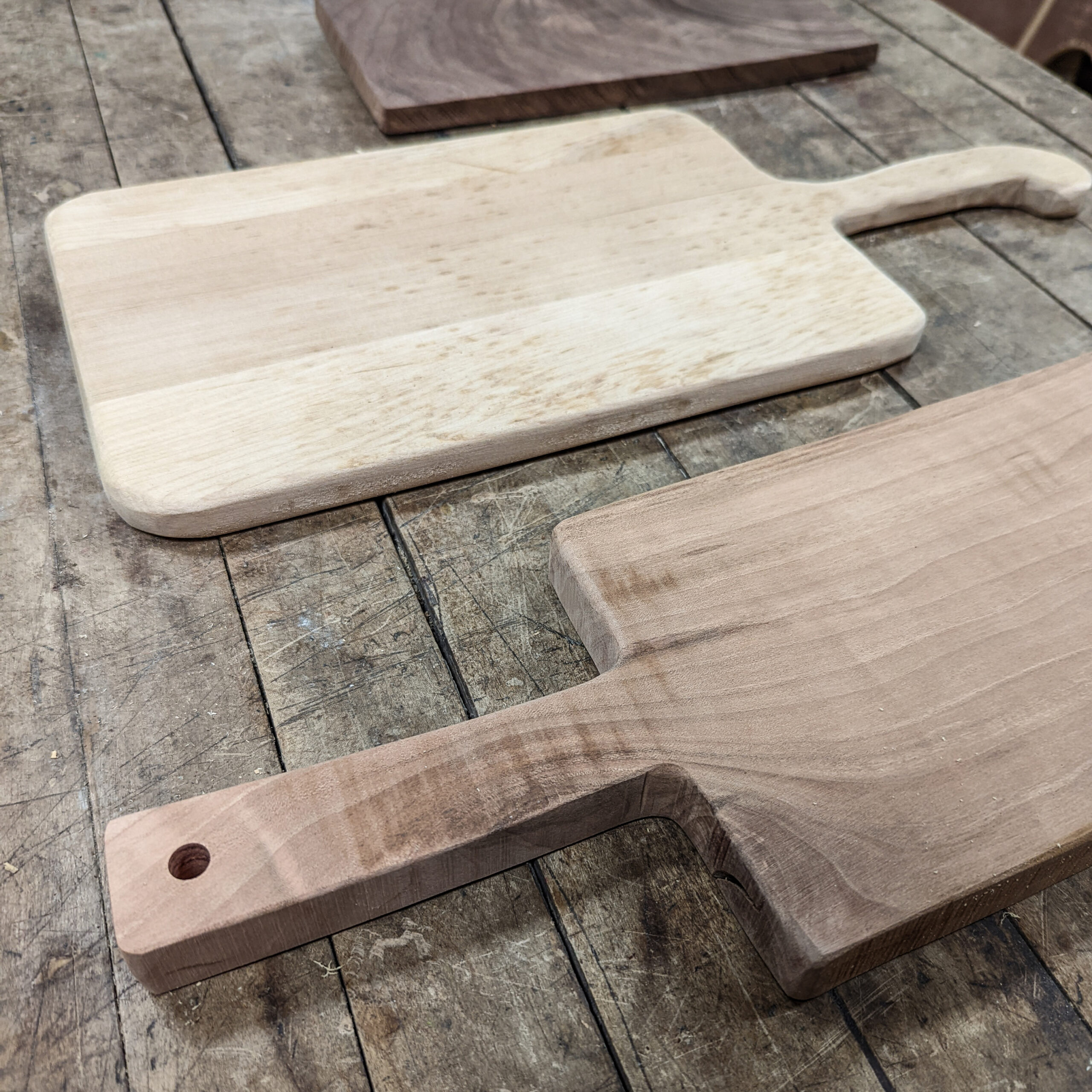 Homemade rustic cutting boards and cheese board made using basic tools in a shared community woodshop.