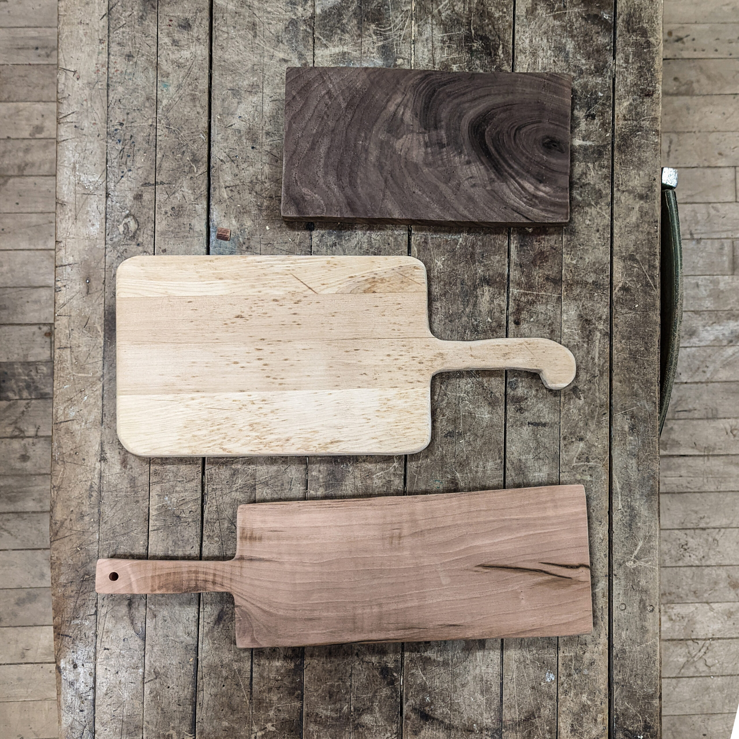 Homemade rustic cutting boards and cheese board made using basic tools in a shared community woodshop.