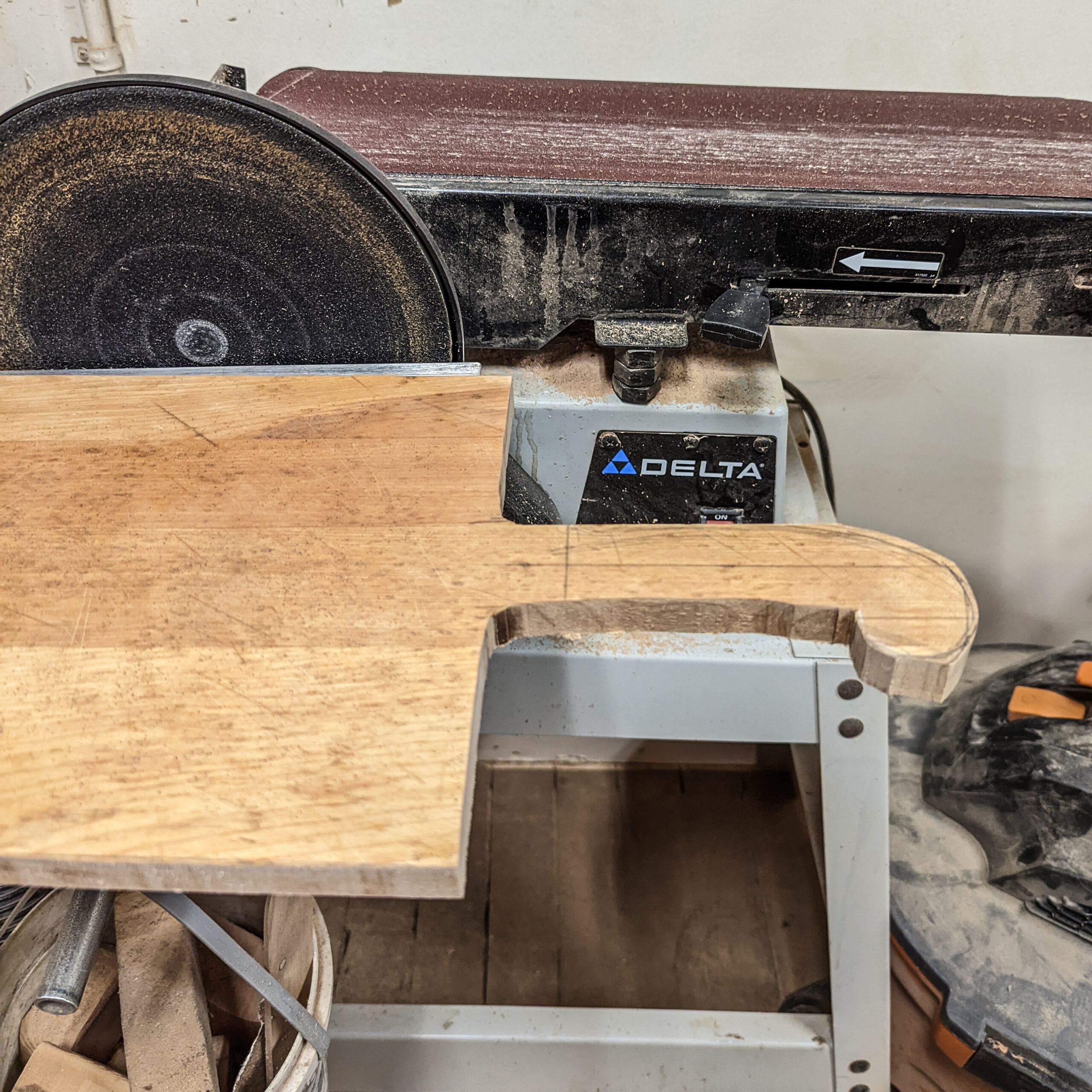 Using a belt sander to soften fresh cuts on a cutting board.