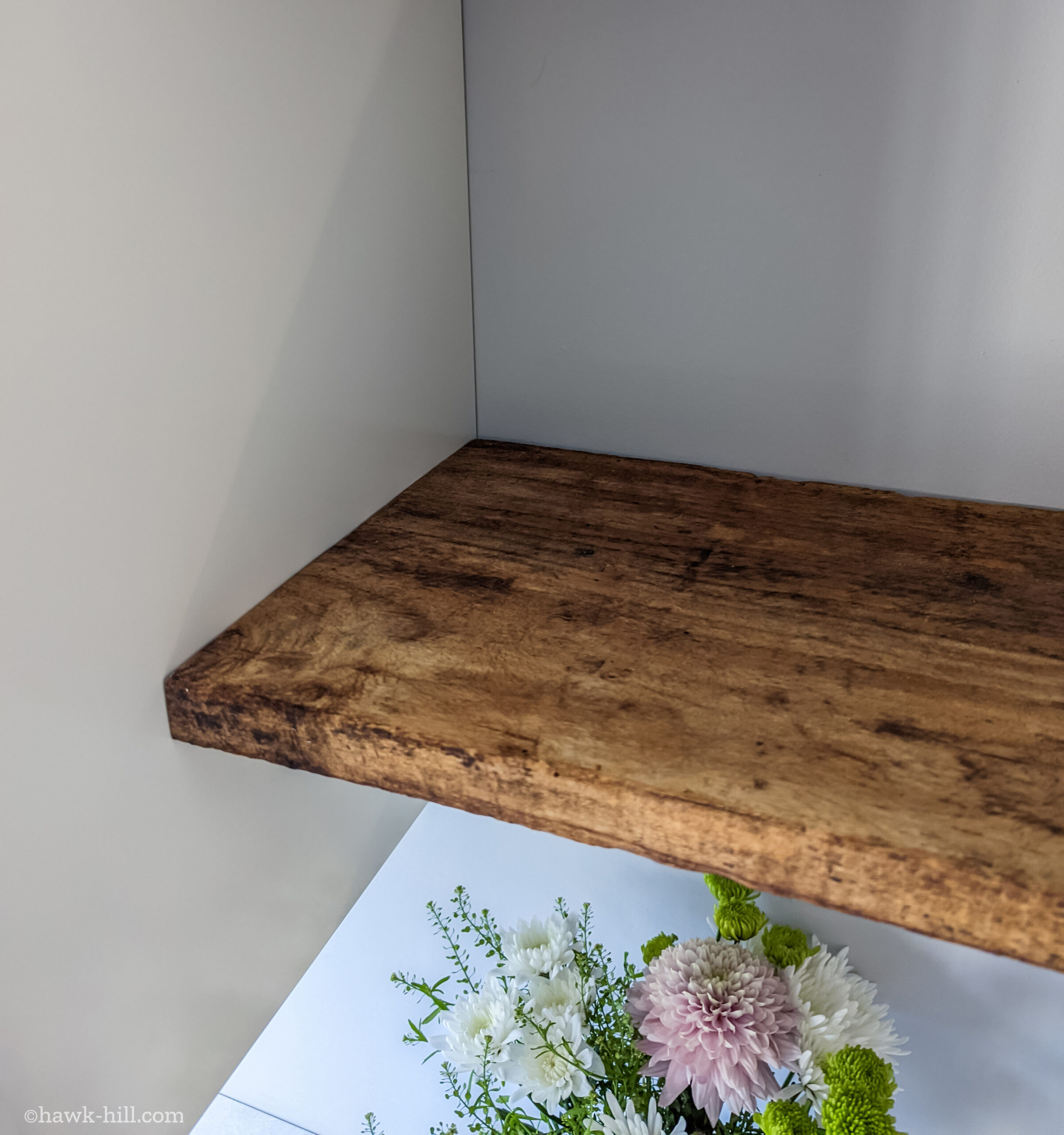 Raw wood Open kitchen shelving made from reclaimed floor joists boards.