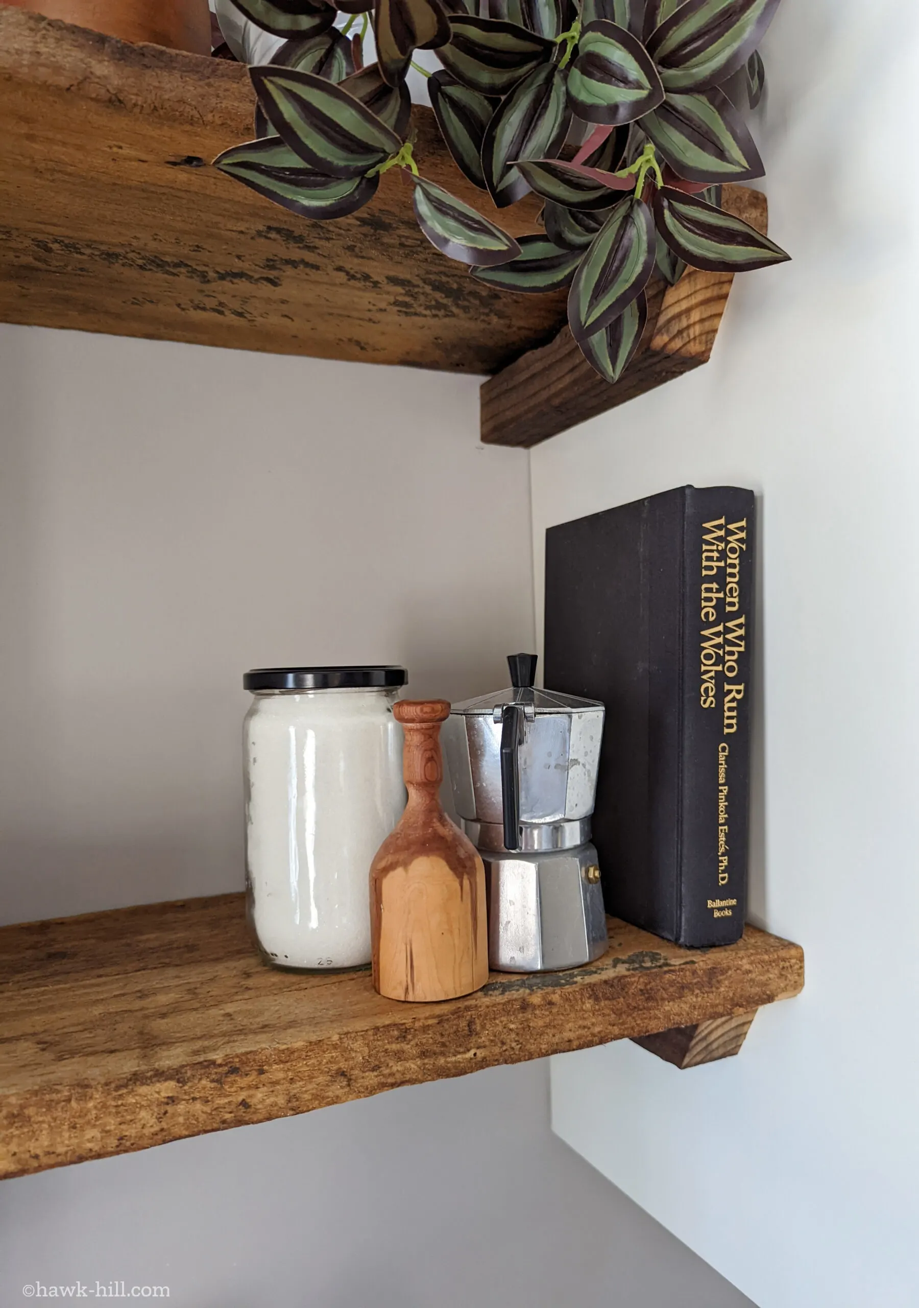 Items displayed on a set of open kitchen shelves made from reclaimed floor joists.