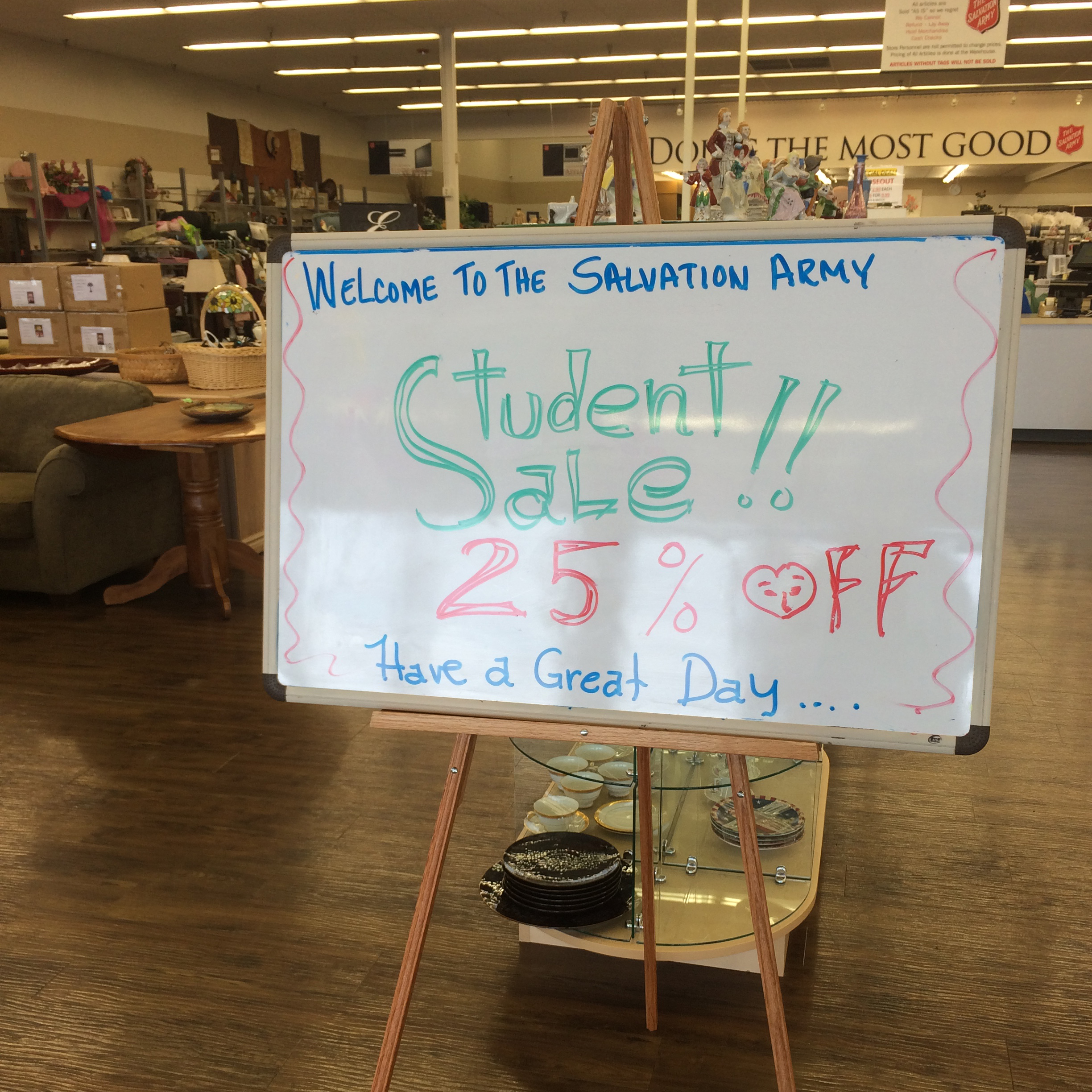 A sign advertising a thrift store sale