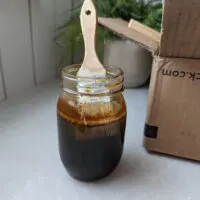 A mason jar of homemade vinegar based wood stain.