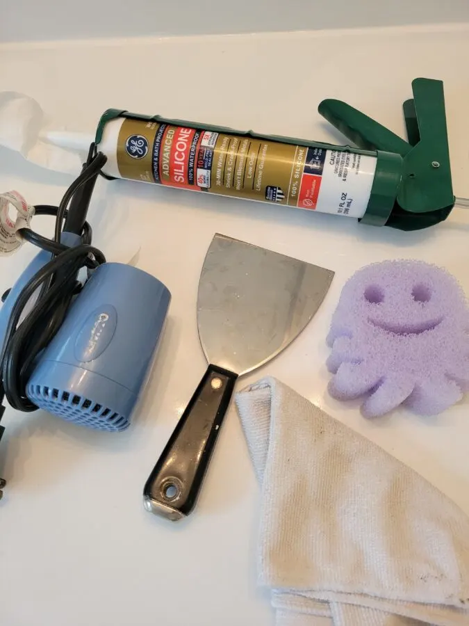tools needed for project. Hair dryer, scraping tool, fresh caulk, scrub daddy sponge. 